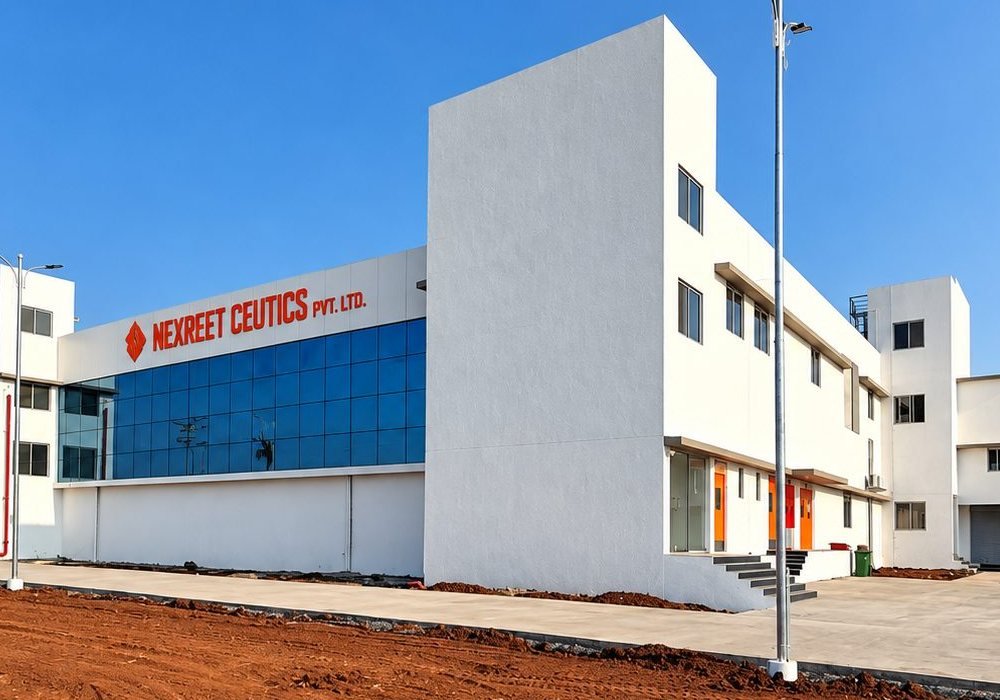 Exterior of the Nexreet Ceutics building with glazed façade and company signage under a clear blue sky